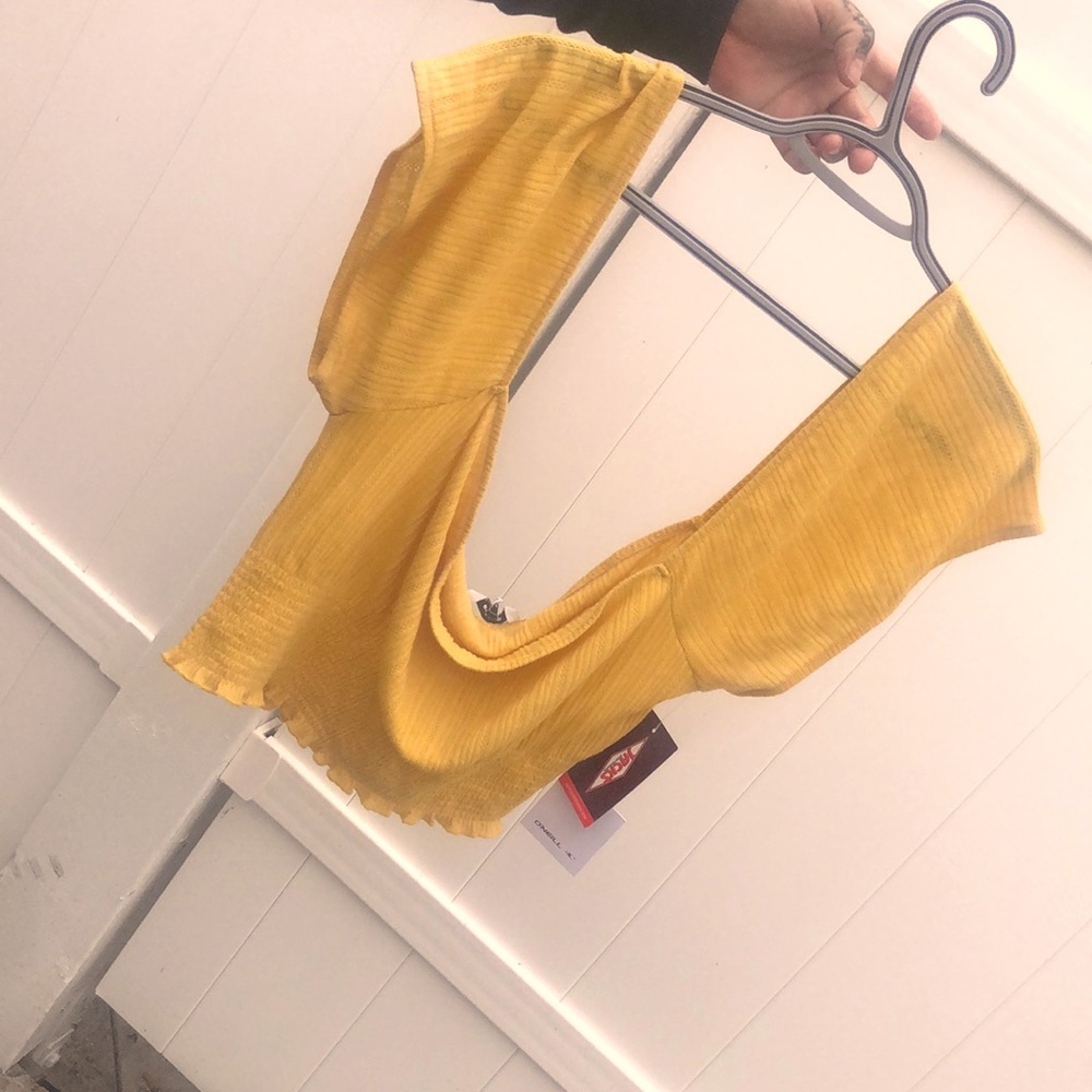 Yellow blouse sequenced with a pretty pattern and is brand new with tags